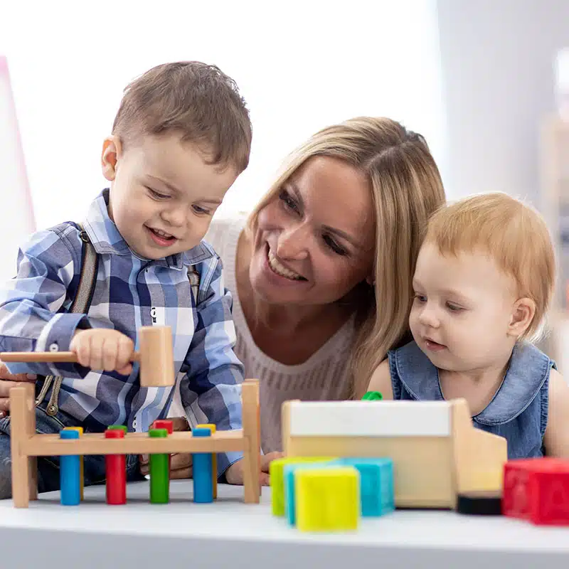 A Giggle and Grow teacher reading and playing with children
